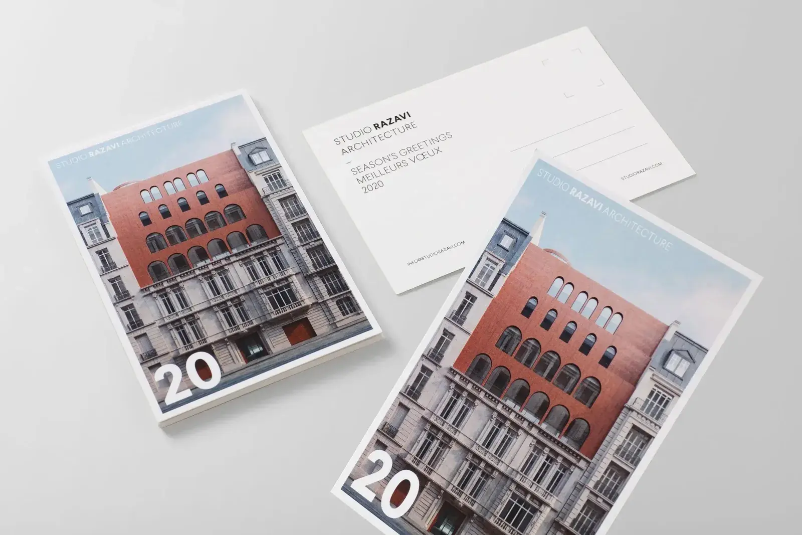 The front and back of a postcard for an architecture studio, with a photo of a red brick building